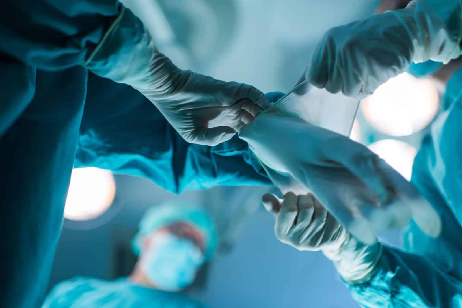 Doctors putting on on gloves before surgery