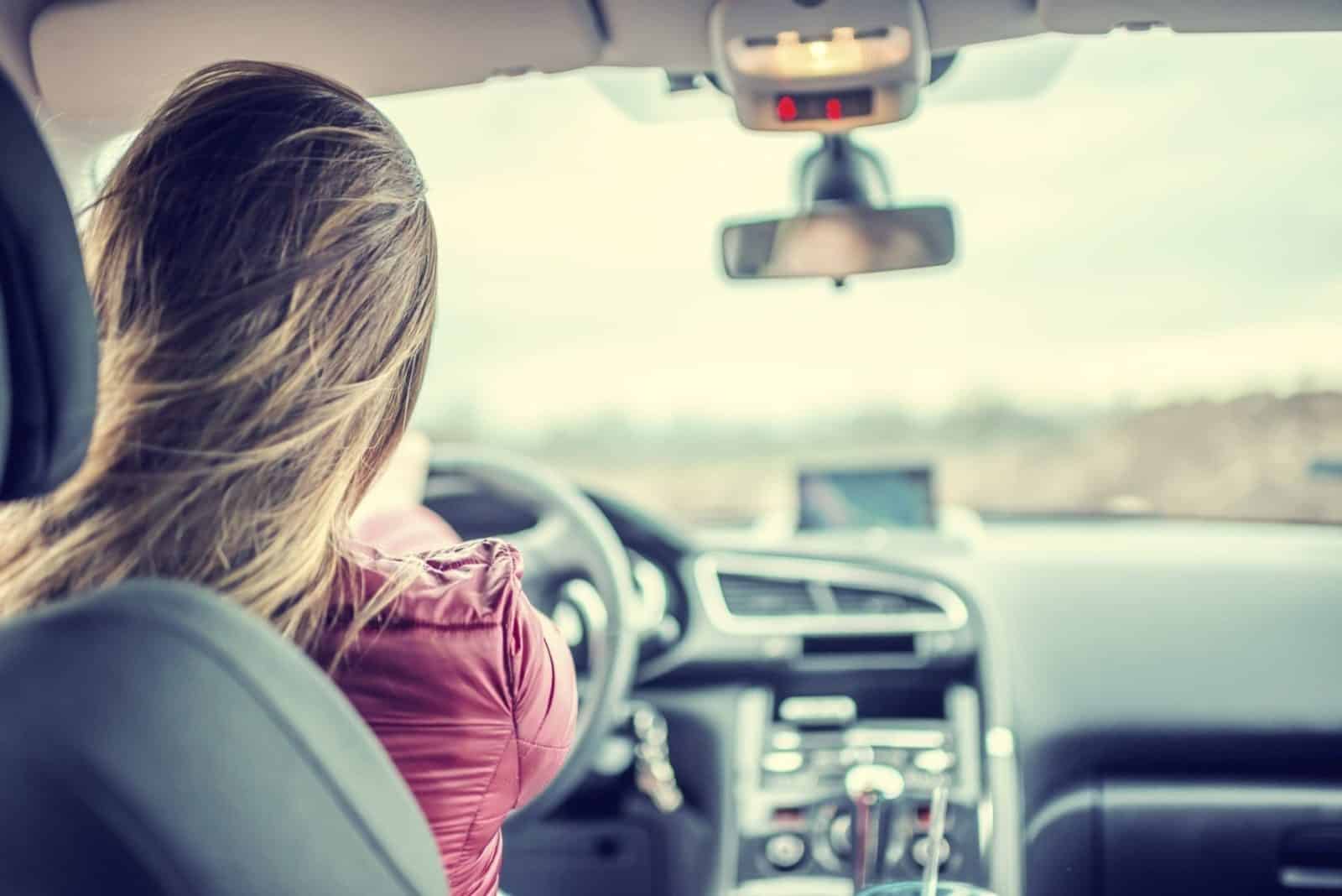 Woman Driving Her Vehicle During The Day Stock Photo