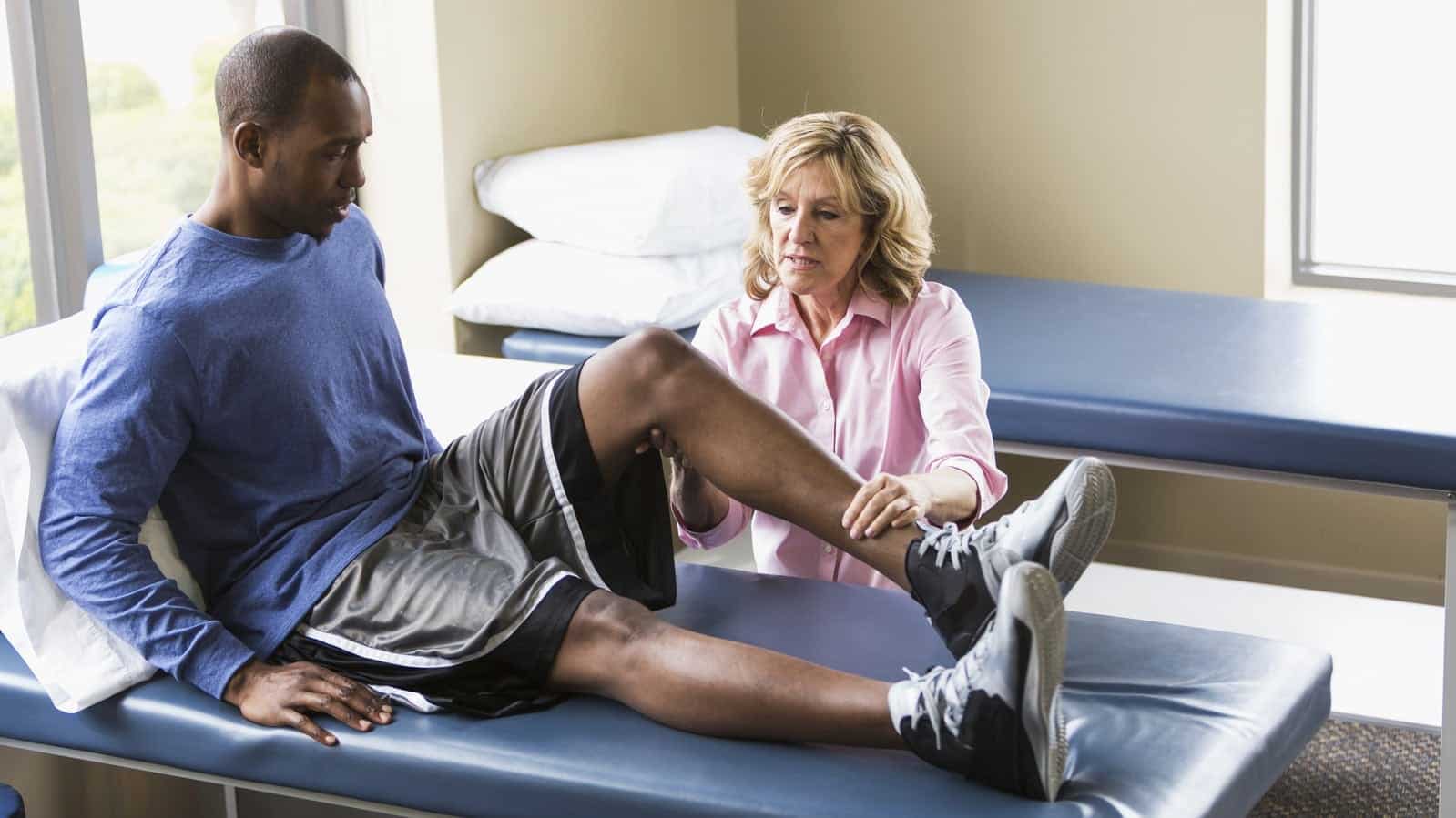 Doctor Examining Male Patient Stock Photo