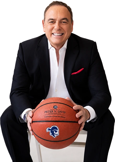 peter davis sitting and holding a basketball
